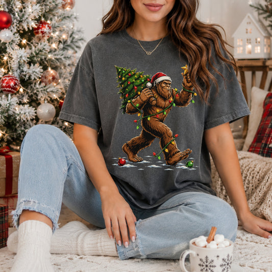 Sasquatch Carrying Christmas Tree T-Shirt — Holiday Bigfoot Santa Tee
